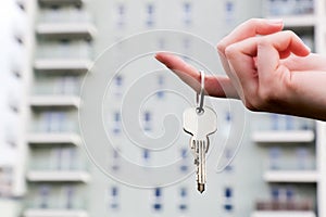 A real estate agent holding keys to a new apartment in her hands.