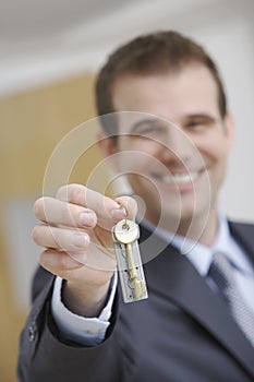 Real Estate Agent Holding Out House Key