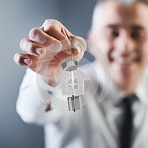Real estate agent holding out house keys