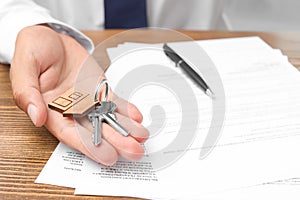 Real estate agent with keys and documents