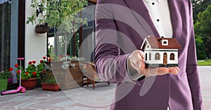 Real estate agent with model against house, space for text. Banner design, closeup