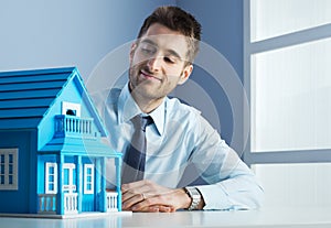 Real estate agent with model house