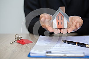 Real estate agent offer house represented by model. ,investment mortgage finance and home loan business