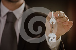Real Estate agent offering house key