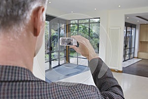 Real Estate Agent Photographing New Property