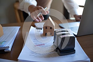 Real estate agent presenting and approved home loan contract. Real estate investment, home mortgage concept