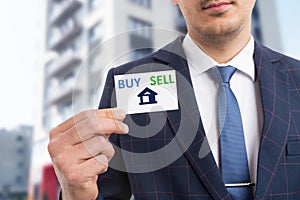 Real estate agent presenting business card with symbol