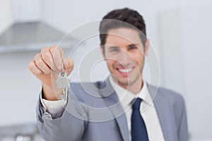 Real estate agent presenting house key