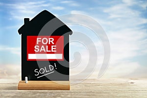 Real estate agent for sale sign and chalk blackboard