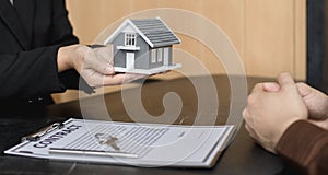 Real estate agent or sales manager has offered home sales and explained the terms of signing the house purchase contract and free