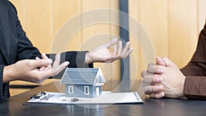 Real estate agent or sales manager has offered home sales and explained the terms of signing the house purchase contract and free