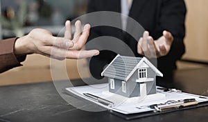 Real estate agent or sales manager has offered home sales and explained the terms of signing the house purchase contract and free