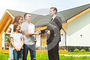Real estate agent is selling an apartment to a young family. conclusion of a lease and purchase of a house, apartment