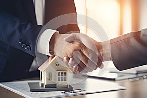 Real estate agent shaking hands with customer after signing contract to buy house or home with approved property application form