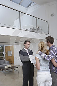 Real Estate Agent Showing Couple New Home