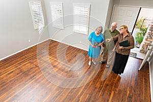 Real Estate Agent Showing Senior Adult Couple A New Home