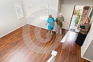 Real Estate Agent Showing Senior Adult Couple A New Home