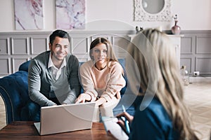 Real-estate agent shows a build project to a young couple