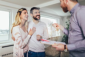 Real Estate agent shows interior to couple