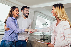 Real Estate agent shows interior to couple