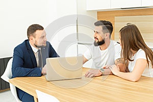 Real estate agent shows a young couple a new home. family buys housing