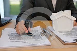 real estate agent stamping approved on mortgage loan contract ag