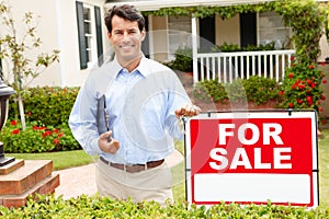 Real estate agent standing outside house