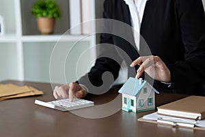 Real estate agent talk to new homebuyers and offer good interest rates and calculate clients on mortgage finance