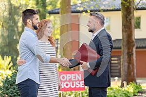 Real estate agent welcoming couple