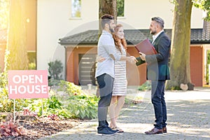 Real estate agent welcoming visitors