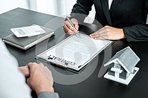 Real estate agent working sign agreement document contract for home loan insurance approving purchases for client with house model