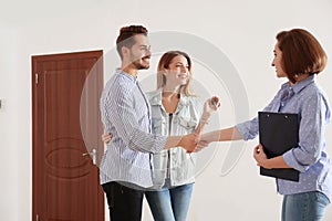 Real estate agent with young couple