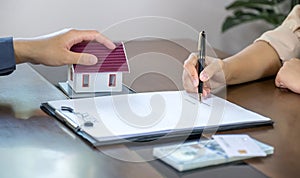 Real estate agents and buyers discuss signing a business contract, renting, buying, mortgage, loan or home insurance