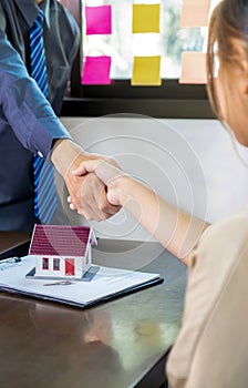 Real estate agents and buyers handshake after signing a business contract, renting, buying, mortgage, loan or home insurance