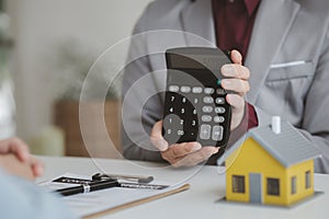 Real estate agents explain models of housing estates in projects to elaborate to clients, explaining and presenting information