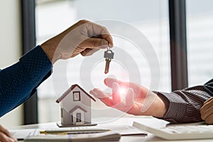 Real estate agents hand out keys to customers after signing the lease. Or buy a home with a home loan and home insurance deals at