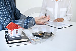 Real estate broker agent being analysis and making the decision a home estate loan to customer to signing contract documents for