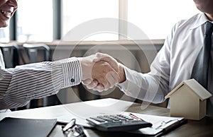 Real estate broker agent and customer shaking hands