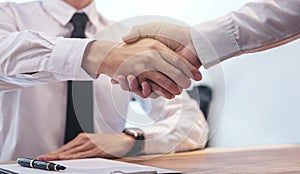 Real estate broker agent and customer shaking hands after signin