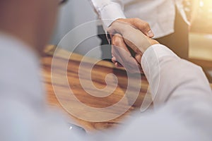 Real estate broker agent and customer shaking hands after signing contract documents for realty purchase, Bank employees