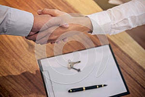 Real estate broker agent and customer shaking hands after signing contract documents for realty purchase, Bank employees