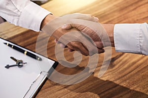 Real estate broker agent and customer shaking hands after signing contract documents for realty purchase, Bank employees