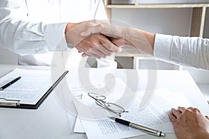 Real estate broker agent and customer shaking hands after signing contract documents for realty purchase, Bank employees