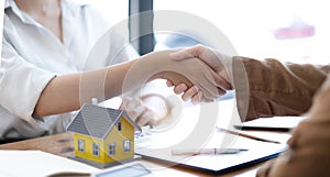 Real estate broker agent and customer shaking hands after signing contract documents for realty purchase, Bank employees