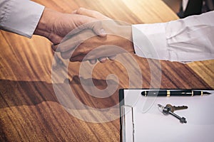 Real estate broker agent and customer shaking hands after signing contract documents for realty purchase, Bank employees