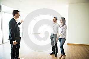 Real Estate Broker Showing Couple A New House photo