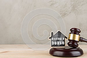 Real estate concept auction gavel and little house with inscription Buying a house