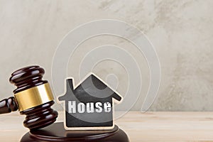 Real estate concept auction gavel and little house with inscription House