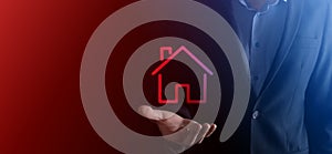 Real estate concept, businessman holding a house icon.House on Hand.Property insurance and security concept. Protecting gesture of