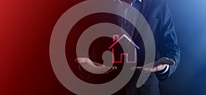 Real estate concept, businessman holding a house icon.House on Hand.Property insurance and security concept. Protecting gesture of